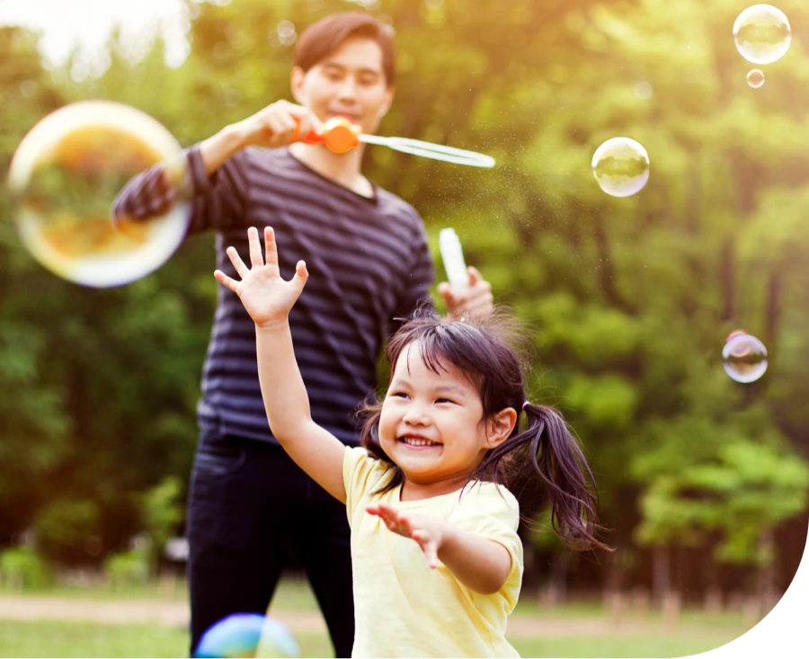 Father and daughter playing with bubbles